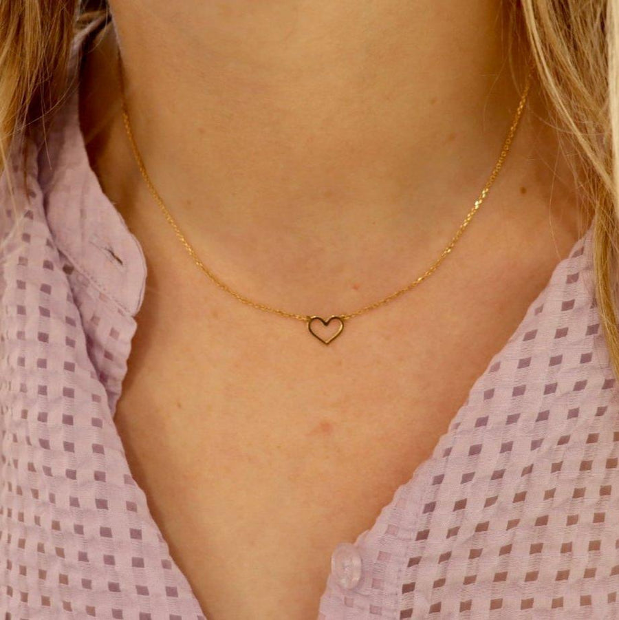 9ct gold open heart necklace on a woman's neck