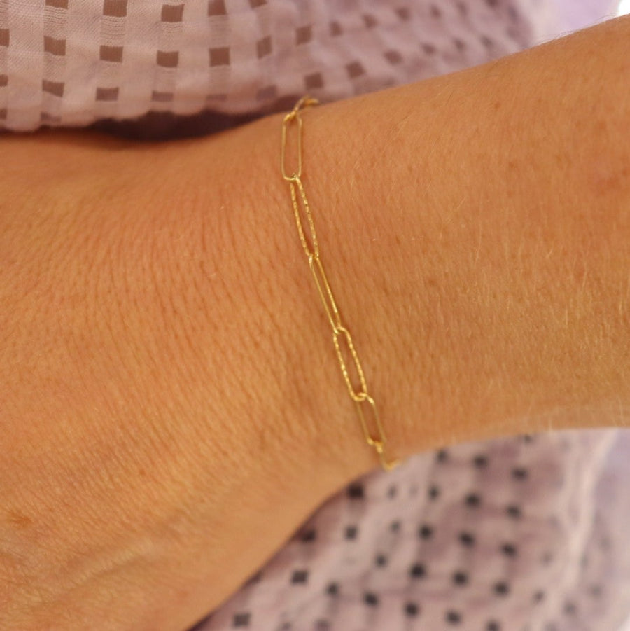 9ct gold textured link bracelet on a woman's wrist