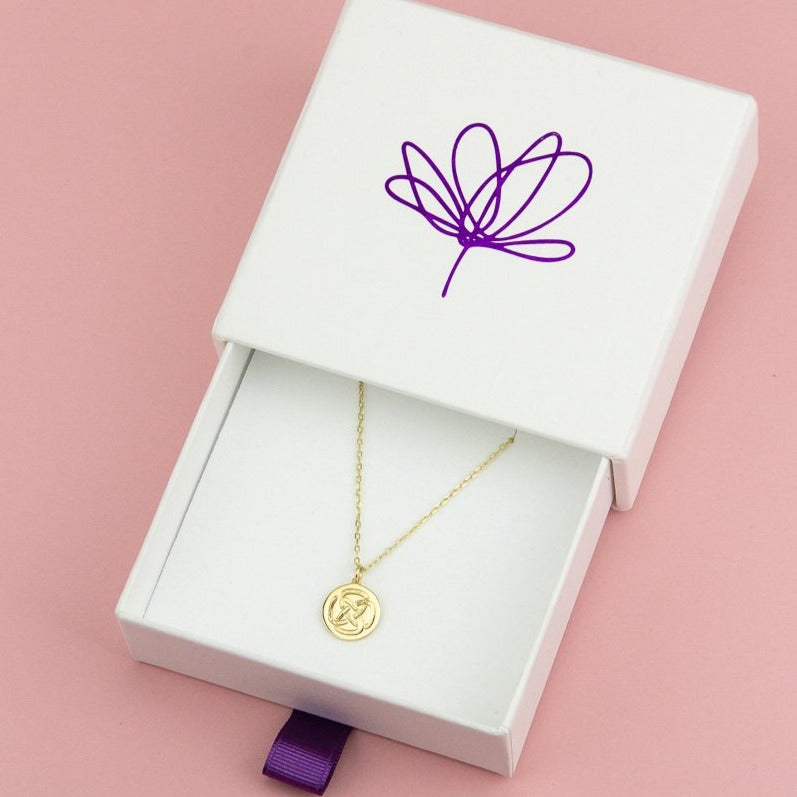 9ct gold dara knot necklace inside biodegradable box