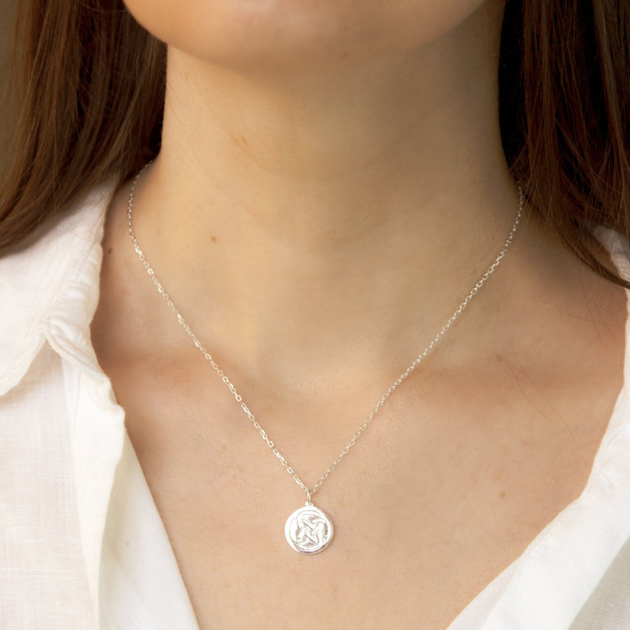 sterling silver necklace symbolic for strength on a woman's neck 